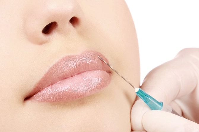 Woman getting a botox injection in her lips