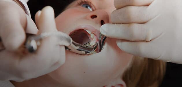 Young child getting a tooth extracted