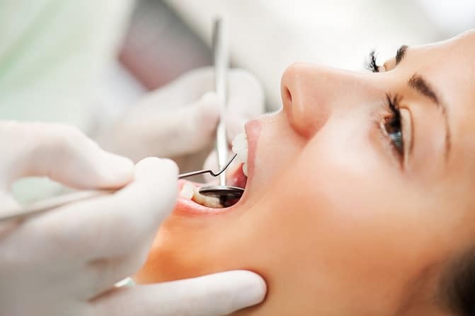 Woman in a dental chair having teeth cleaned