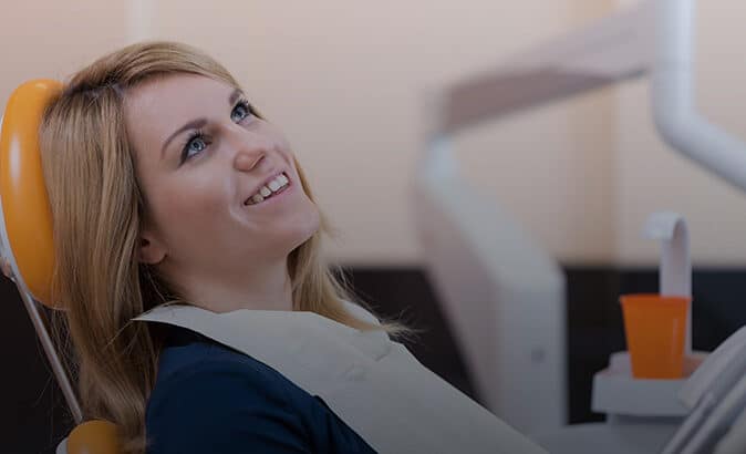 Woman leaning back in a dental chair