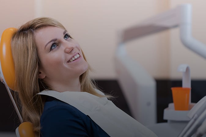 Woman leaning back in a dental chair