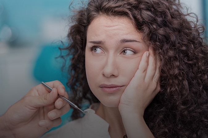 Young woman holding mouth with a sad face